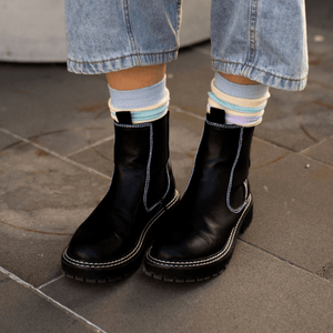 Black leather boots paired with Lamington Merino Wool Socks in pastel colours, NZ-made.