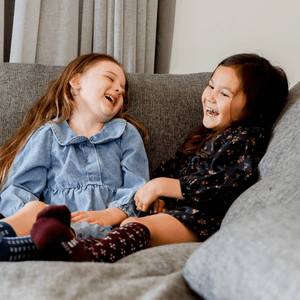 Child wearing Lamington merino knee high socks in fig with lilac cross pattern made in New Zealand.
