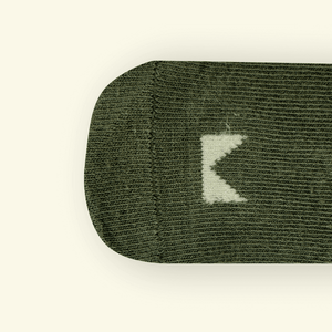 Top view of Sage Organic Cotton Baby Socks highlighting the textured fabric and Mosey logo detail.
