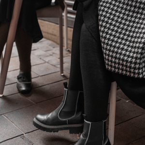 Woman wearing Mosey by Lamington women's merino textured knit tights in black.