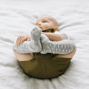 Merino Wool Knee High Socks for Baby in Snowflake pattern, light grey marle with natural spots, perfect for delicate skin.