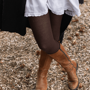 Woman wearing Mosey by Lamington women's merino wool textured knit tights in mocha.
