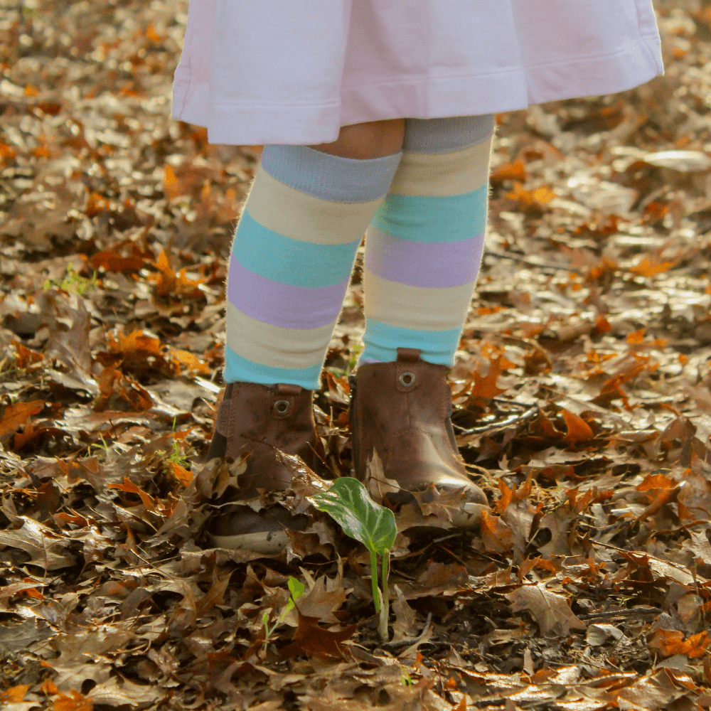 Merino Wool Knee High Socks for Child in pastel stripes of blue, yellow, green and purple, offering warmth and comfort.