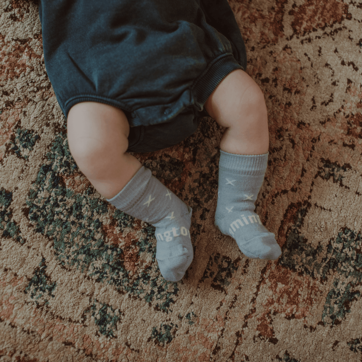 Merino Wool Crew Socks for Baby in Beau - Light Blue with Natural Cross pattern on a baby's feet.