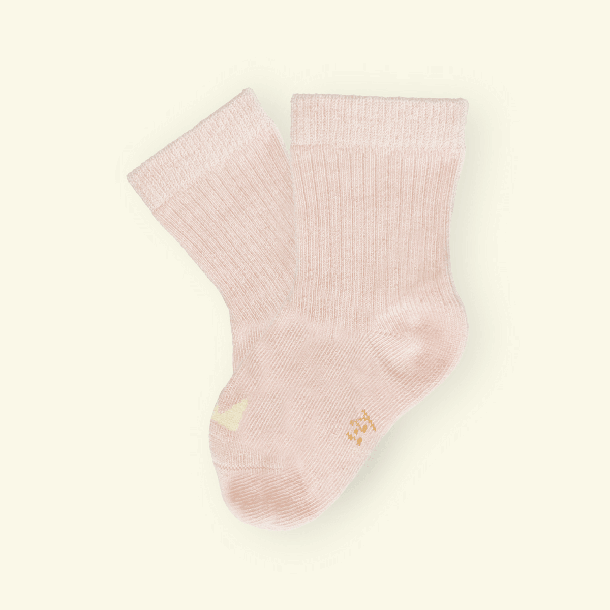 Soft blush Organic Cotton Baby Socks with a cozy ribbed design, perfect for tiny feet.