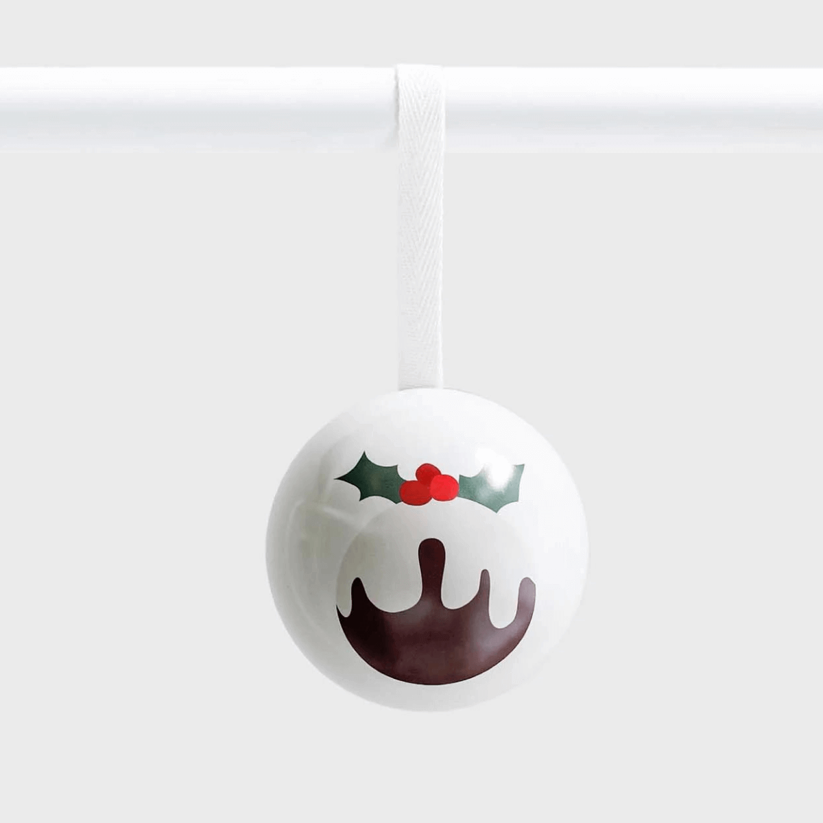 white tin bauble decoration with Christmas pudding design