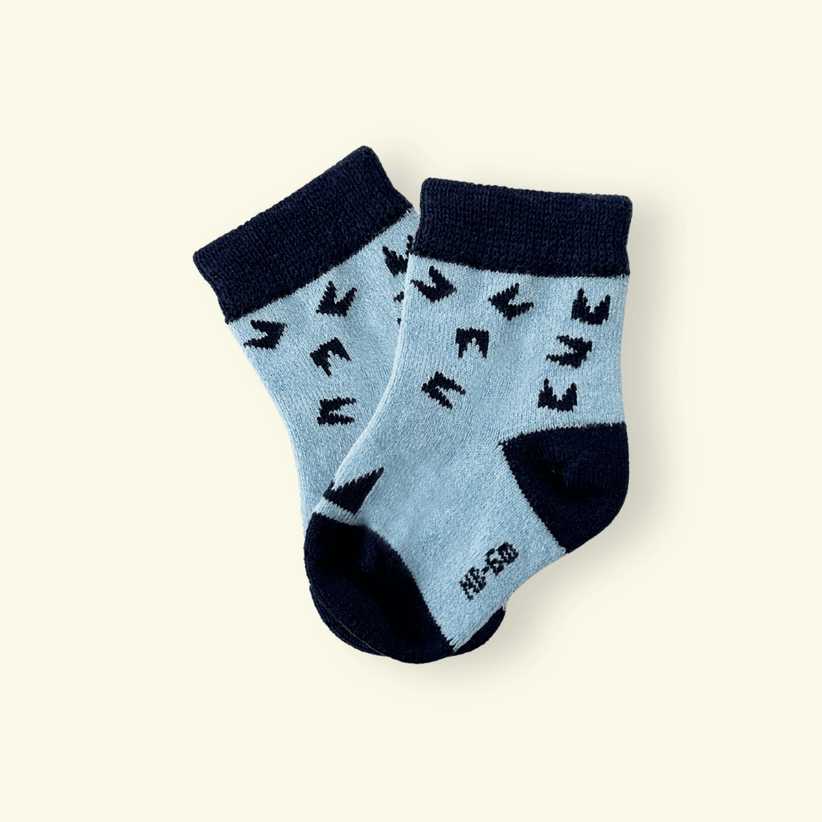 Merino Wool Baby Socks in Night featuring a modern design with a cozy feel and Mosey’s logo pattern.