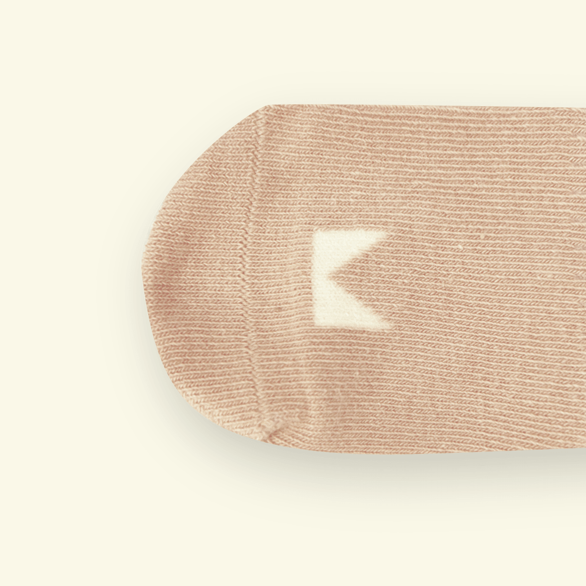 Organic Cotton Baby Socks in Oatmeal with a Mosey logo near the toe, soft and snug for tiny feet.