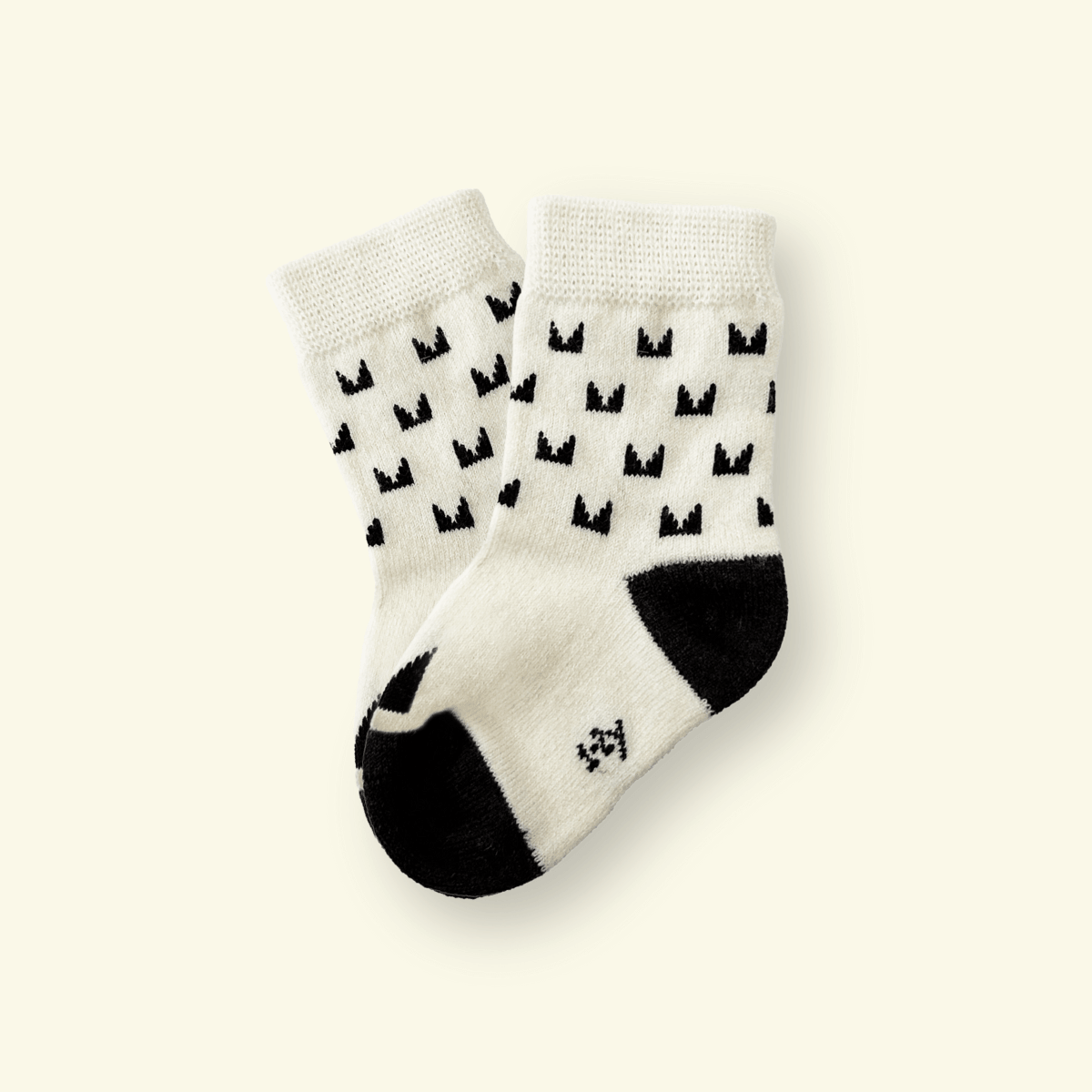 Merino Wool Baby Socks in cream color with black pattern, designed for comfort and warmth.
