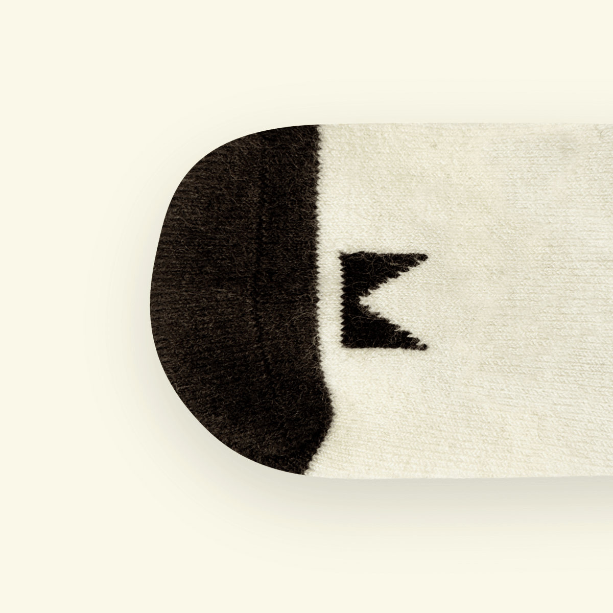 Merino Wool Baby Socks in cream color with black pattern, designed for comfort and warmth.