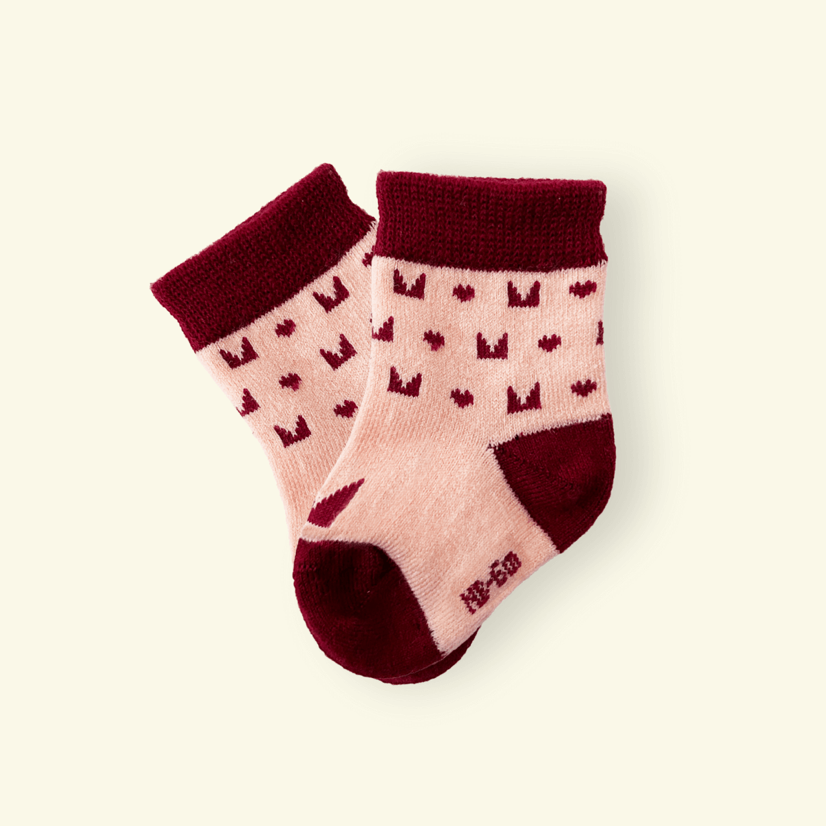 Merino Wool Baby Socks in Plum with playful logo pattern for infants, designed for comfort and warmth.