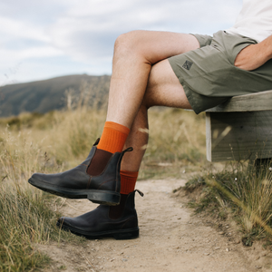 man wearing orange rust merino wool socks crew nz